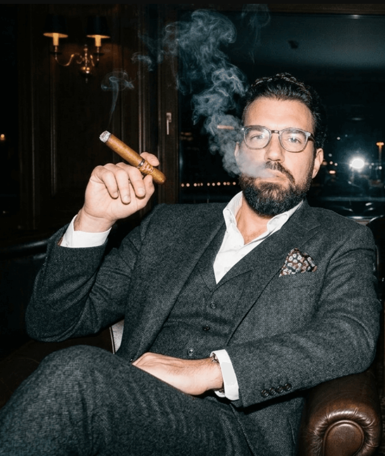 Ross Belhomme seated with a cigar